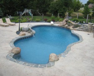 Vinyl Liner Pool with hancarved Waterfall and themed privacy fence, wine barrell water feature and chlorine generating salt system in Saline MI by Legendary Escapes Pools (12)